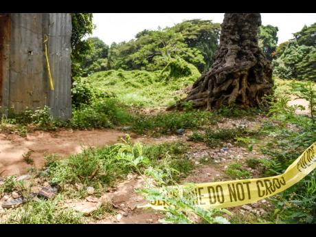 A pair of slippers and yellow caution tape left at the crime scene in Jones Avenue, Spanish Town, where 15-year-old Kevin McKenzie was murdered in 2021.