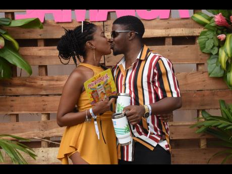 Lovebirds Krystal Senior (left) and Kevaun Tyrrell get a sip of each other as they share a kiss at the festival.