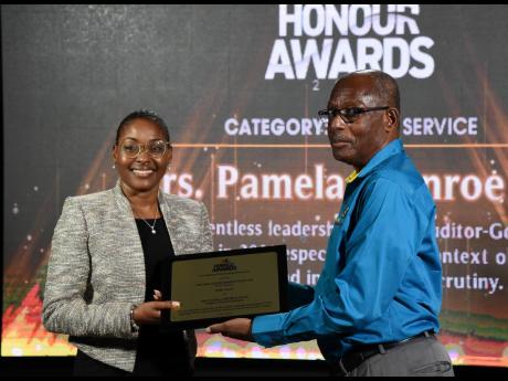 Auditor General Pamela Monroe Ellis is presented with the RJRGLEANER Honour Award for Public Service by Carl Domville, chairman of The Gleaner Company (Media) Limited. Monroe Ellis was recognised for her relentless leadership of the Auditor General’s Dep