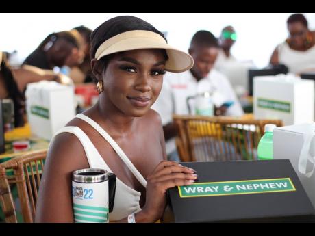 Brittany Miller, owner of Beat Place 876, was seen trying to take a sneak peek into her J. Wray & Nephew Limited Culture in a Cup seminar kit.