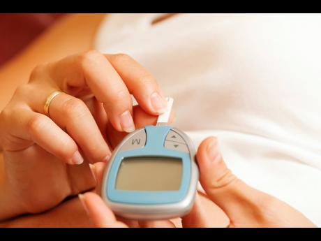 Credit: Theodore Johnson A woman testing her blood glucose level.