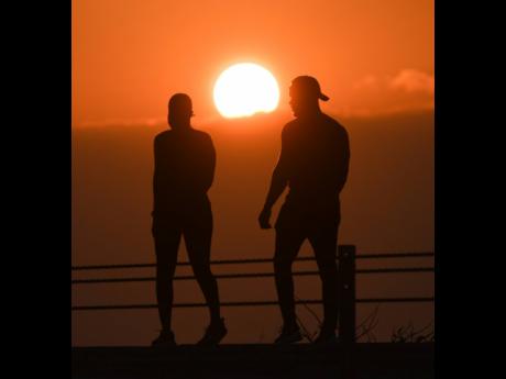 Credit: Ricardo Makyn A man and woman walk for exercise.