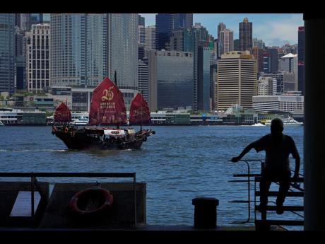 A Chinese junk sails across Victoria Harbor to celebrate the 25th anniversary of Hong Kong handover to China, in Hong Kong, Monday, June 27, 2022. 