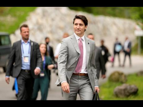 Canada’s Prime Minister Justin Trudeau, right, walks to a media conference near the G7 venue at Castle Elmau in Kruen, Germany, on Tuesday, June 28.