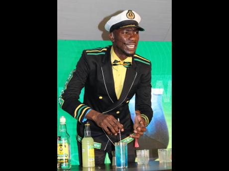 Credit: Stephanie Lyew Mixologist St Aublyn Kidd, more popularly known as 'Captain Kidd', brings the energy as he demonstrates mixing the 'Purple Wray'.