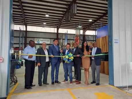 Prime Minister Andrew Holness (third left) and CEO of Isratech, Benjie Hodara (fourth right), officially opening the company’s superstore and logistics centre at their headquarters in Shooter’s Hill, Manchester, on Wednesday. Others participating in th