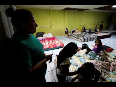 Iracema Figueroa (left), of Honduras, looks on as her children play with others at a shelter for migrants in Tijuana, Mexico, in May. The Supreme Court has ruled that the Biden administration properly ended a Trump-era policy forcing some US asylum-seekers