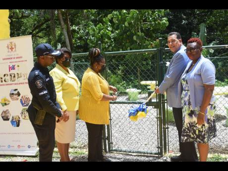 Homer Davis (second right), minister of state in the Office of the Prime Minister West, participates in a ribbon-cutting ceremony for the opening of a new park and greenspace at the Lethe Primary and Infant School in Lethe, St James, on Thursday, June 30. 