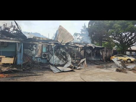 The remains of the old Jamaica Railway Corporation building that was destroyed by fire on Saturday in Port Antonio, Portland.