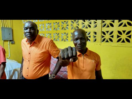Desmond Lewis (left), councillor-caretaker of the Buff Bay Division, and Peter Evans, councillor-caretaker for the Hope Bay Division of the Portland Municipal Corporation during a divisional conference in west Portland on Sunday.