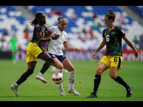Jamaica’s Deneisha Blackwood (left)  and Havana Solaun (right) compete for the ball with United States’ Sophia Smith  during a Concacaf  Women’s Championship football match in Monterrey, Mexico, last Thursday. The United States won 5-0.