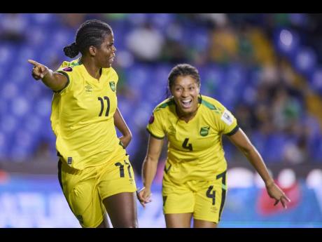 Reggae Girlz captain Khadija Shaw (left) and teammate Chantelle Swaby.