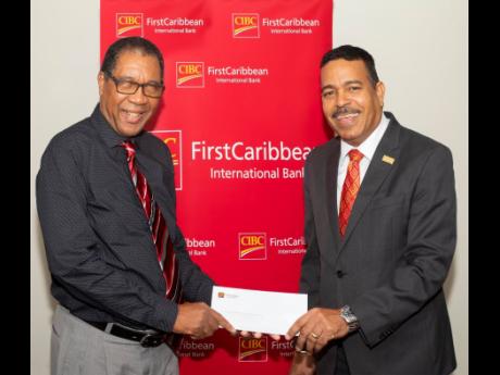 Nigel Holness (right), managing director, CIBC FirstCaribbean, presents a cheque in support of the work of the Combined Disabilities Association to its chairman, Deacon Arthur Taylor. The association is a cross-disability, non-profit organisation located i