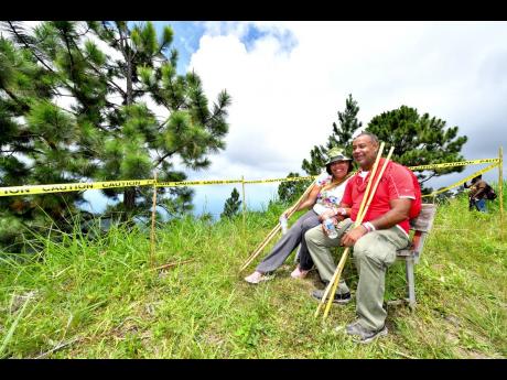 Two trekkers take a breather at Rick’s Bench, about half-way through the recent hike. 