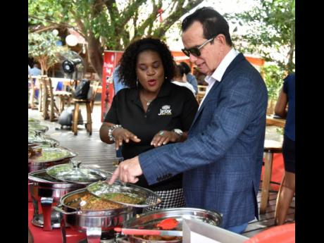 Chief executive officer of Downsound Records and executive producer of Reggae Sumfest,  Joe Bogdanovich, engage in discussions with Ingrid Medwinter, brand manager for Grace Foods. Chief executive officer of Downsound Records and executive producer of Regg