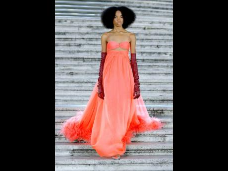 Shantae Leslie walks the runway for Valentino in a peach gown. 
