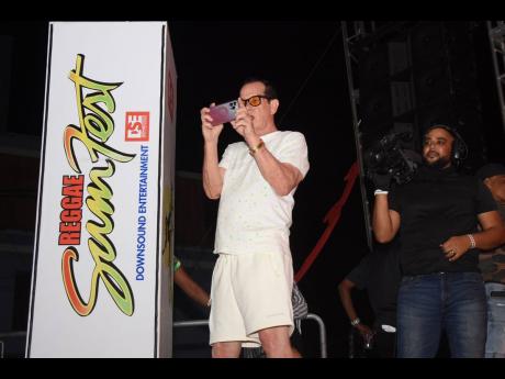 Joe Bogdanovich, promoter, Reggae Sumfest and chief executive officer of Downsound Entertainment, records the clash from the sidelines.