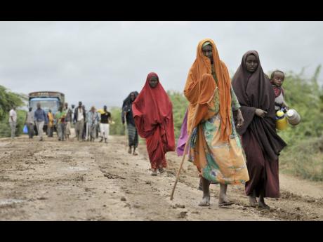 Credit: AP/ File
In this August 2014 photo, civilians who had left the town of Bulomarer when it was held by al-Shabab militants, return following the town’s capture by African Union and Somali government soldiers, in the Lower Shabelle region of Somalia.