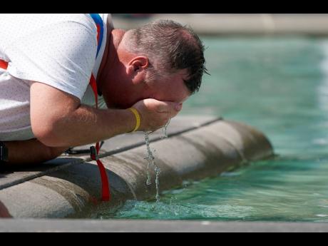 A man refreshes his face at a fountain in Trafalgar Square in central London. Global temperatures are hitting record highs. In England, 38 degrees Celsius+ (100 degrees Fahrenheit for us old-timers), once unimaginable, are commonplace.