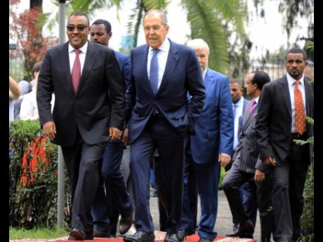 Credit: AP Russian Foreign Minister Sergey Lavrov (centre), walks with Ethiopian Deputy Prime Minister Demeke Mekonnen (left), as they visit the compound of the Russian Embassy in Addis Ababa, Ethiopia on July 27.