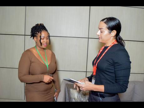 Sotheby’s Agent Kerrine Tolluch (left), talks with Club Kingston Business Development Manager Simone Burke.