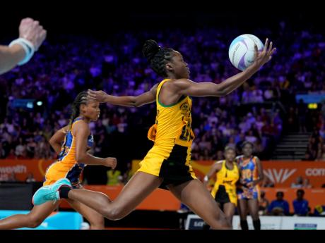 Jamaica's Shanice Beckford takes control of the ball during a Netball Pool A match against Barbados at the Commonwealth Games inside The NEC in Birmingham, England on Monday.