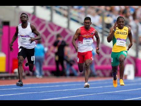 Conroy Jones (right) of Jamaica runs in his men's 100m heat in the Alexander Stadium at the Commonwealth Games in Birmingham, England, Tuesday, August 2, 2022. 