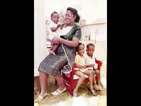 Credit: Contributed Sylvia Kirlew holds her Independence gem Topaz while siblings Therese (second right) and Konrad look on.