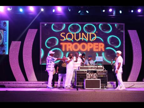 Credit: Stephanie Lyew Veteran entertainers hold a reasoning on stage as Sound Trooper cues the next riddim for their performance.