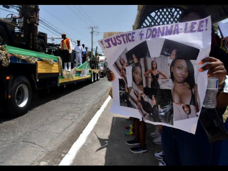 Jamaica Defence Force personnel drive past supporters of Donna-Lee Donaldson, the missing social-media influencer, who mounted a protest. 