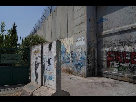 
The original location of a missing mural by the secretive British graffiti artist Banksy was mysteriously transferred from the occupied West Bank to the Urban Gallery in Tel Aviv, near a section of the Israeli separation barrier, in the occupied West Bank
