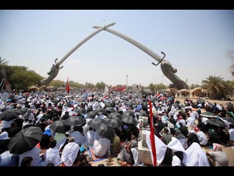
Followers of Shiite cleric Muqtada al-Sadr gather during an open-air Friday prayers at Grand Festivities Square within the Green Zone, in Baghdad on Friday.