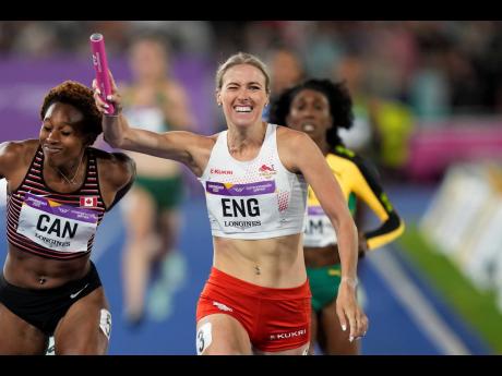 England's Jessie Knight (centre) crosses the finish line ahead of Krya Constantine (left) of Canada and Jamaica's Natoya Goule in the women's 4x400 meters relay at the Alexander Stadium at the Commonwealth Games in Birmingham, England on Sunday. England we