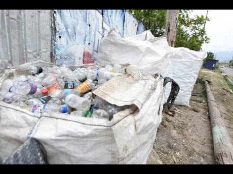 Huge bags filled with bottles collected from the dump in Riverton City, St Andrew, are seen along the road leading to the disposal facility. Sorters and other interests are concerned about the impending closure of the dump. 