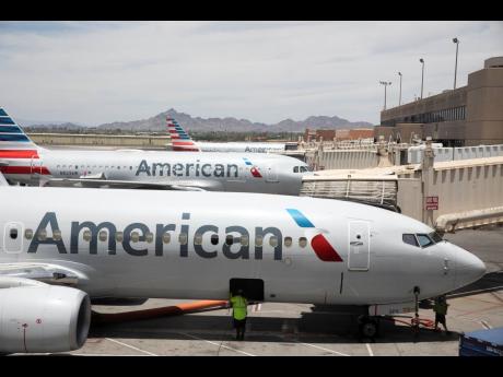Credit: AP American Airlines aircraft wait at gates at Phoenix Sky Harbor International Airport in Phoenix, on June 7, 2021.