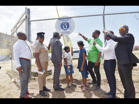 From left: Lennox Wallace, manager at the St James Public Health Services; Angella McIntosh Gayle, deputy superintendent of police in St James; Bishop Conrad Pitkin, custos of St James; Christmar Doeman, and a female beneficiary; Heroy Clarke, member of pa