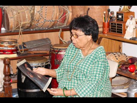 Marjorie Whylie in a reflective mood as she looks at a picture with the Prince of Wales.