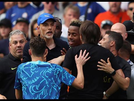 Chelsea’s head coach Thomas Tuchel (centre, blue cap) argues with Tottenham’s head coach Antonio Conte during the English Premier League match between Chelsea and Tottenham Hotspur at Stamford Bridge Stadium in London yesterday.