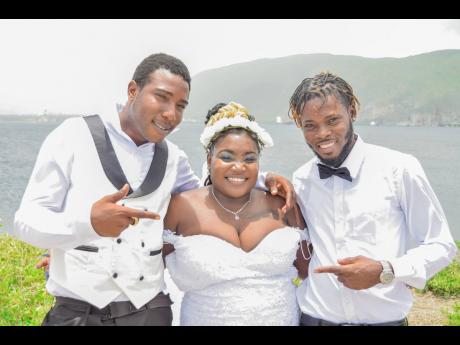 Credit: Shot by Matt The elated bride is joined by best man Carl Dickension (left) and Jahmani Campbell.