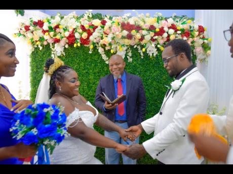 Credit: Shot by Matt The blushing bride held on to her loving groom as they exchanged vows on their wedding day.