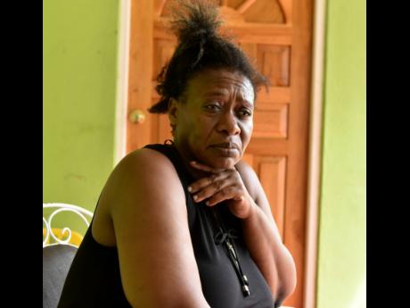 Credit: Kenyon Hemans/Photographer Lluidas Vale resident Karlene Douglas, sister of Jamaican farmworker Dopson Wynter, is overcome with grief days after his death.