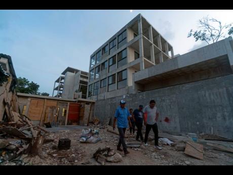 In this photo dated August 4, 2022, people walk where their homes once stood in the ‘October 2’ squatter settlement before their homes were demolished by authorities in Tulum, Quintana Roo state, Mexico.
