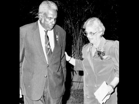 Theodore Sealy, editor emeritus of The Gleaner, listens keenly to Janet, wife of Guyana’s president Cheddi Jagan. 