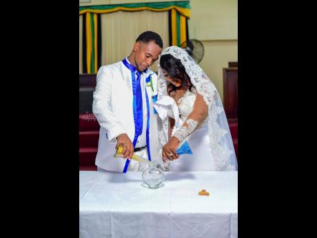 Credit: Contributed O’Shane and Moya take part in the sand ceremony.