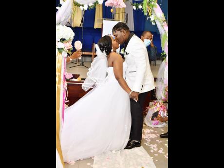 You may now kiss the bride: The Camerons seal their matrimonial love with a kiss.