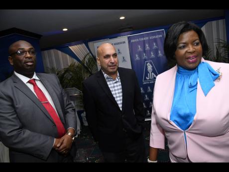 Credit: Rudolph Brown Then president of the Jamaica Teachers’ Association, Dr Garth Anderson (left), is seen in the company of Sagicor Group CEO Christopher Zacca and past president Georgia Waugh Richards at the inaugural launch of the JTA’s Critical Illness Trust Fund at T