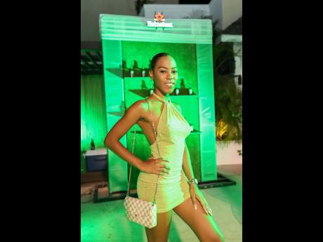 Shakeba McKie welcomed our lenses and was on theme in this lime green halter bodycon dress.