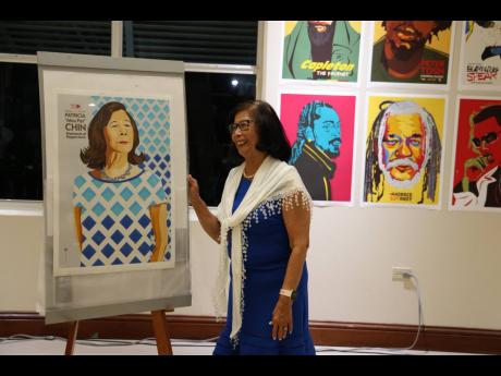 Credit: William Richards Pat Chin poses for a photo with her portrait done by Maria Papaefstathioiu, Greek graphic designer.