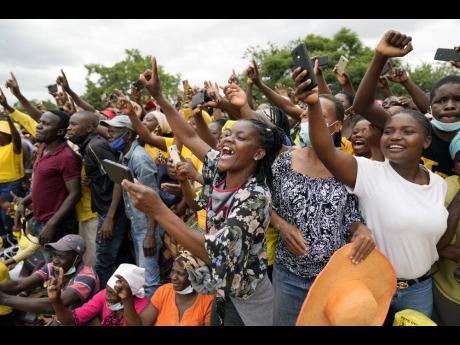 Supporters of Zimbabwean main opposition leader Nelson Chamisa greet him upon his arrival at a rally in Harare on February 20. 
