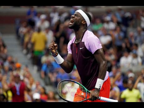 Frances Tiafoe of the United States celebrates after winning a point against Rafael Nadal of Spain during the fourth round of the U.S. Open tennis championships yesterday  in New York. 